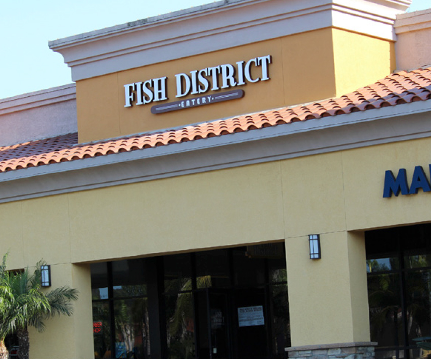 Front entrance of restaurant with Fish District Eatery sign
